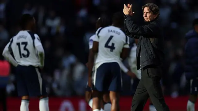 Thomas Frank applauding towards fans after a Tottenham game