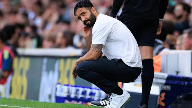 Ruben Amorim crouching on the touchline during the Premier League game between Fulham and Manchester United