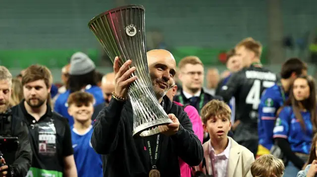Enzo Maresca holds Conference League trophy