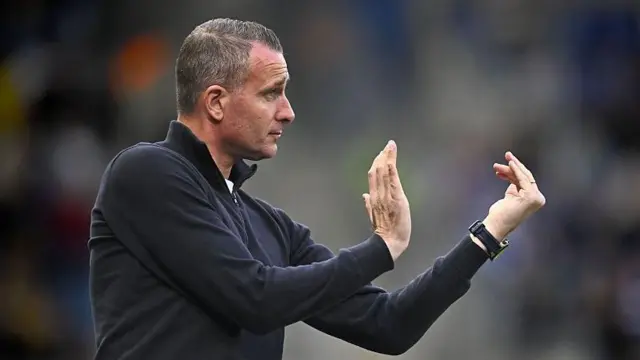Nicky Hayen wearing a dark blue zip jumper coaching his Genk side from the touchline with hand gestures