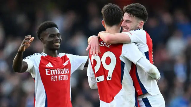 Kai Havertz of Arsenal celebrates with teammates Declan Rice and Bukayo Saka after scoring his team's fourth goal during the Premier League match between Arsenal FC and Leicester City FC at Emirates Stadium