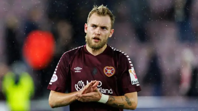 Nathaniel Atkinson applauds Hearts fans at Tynecastle