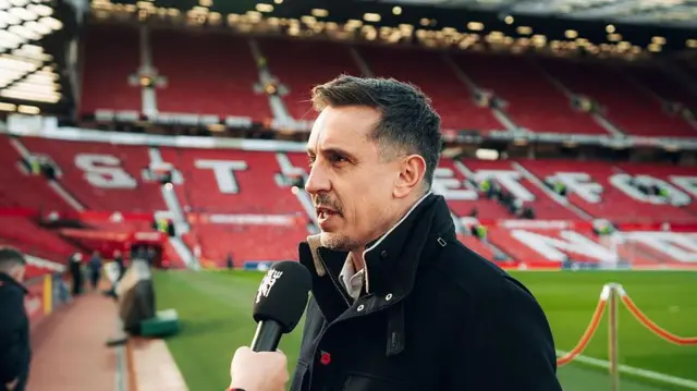 Gary Neville in front of the Stretford End stand