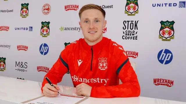 Wrexham striker Davis Keillor-Dunn pictured signing for the club 