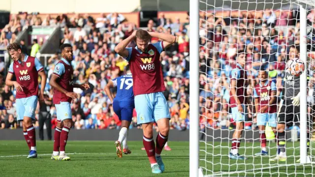 Charlie Taylor of Burnley reacts after Ameen Al-Dakhil of Burnley (not pictured) scores their sides own goal during the Premier League match between Burnley FC and Chelsea FC