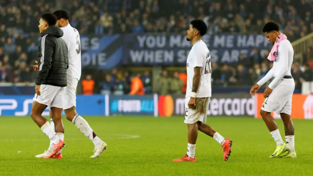 Aston Villa players stand dejected after losing to Club Bruges in the Champions League