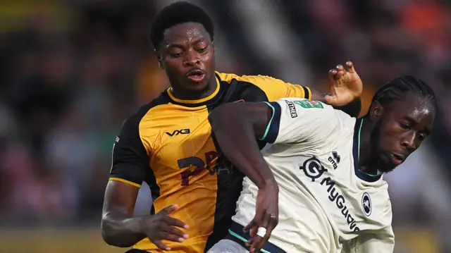 Newport County's Bobby Kamwa battles with Millwall's Karmarl Grant for the ball