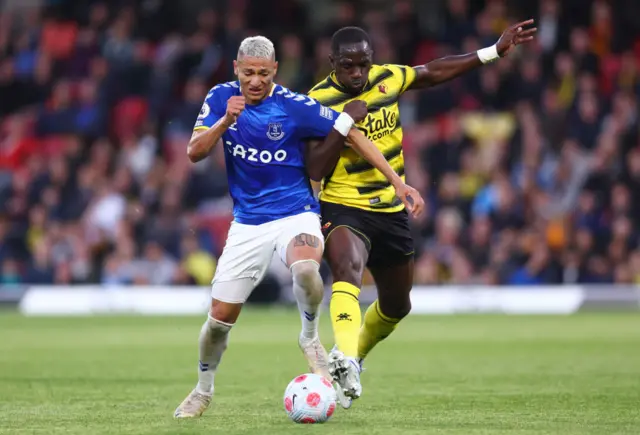 Richarlison and Moussa Sissoko challenge for possession