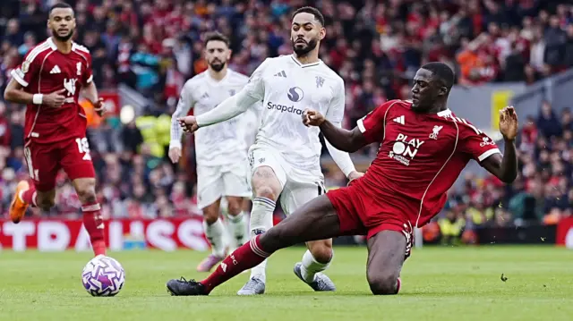 Ibrahima Konate goes in for a tackle against Manchester United