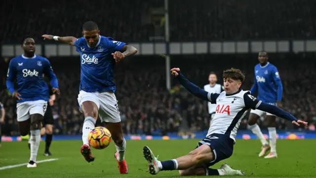 Mikey Moore puts in a slide tackle on Ashley Young