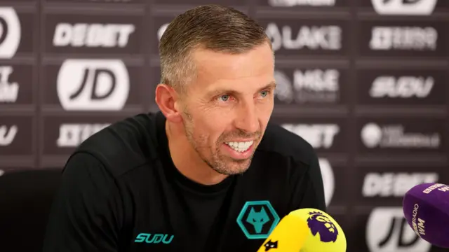 Gary O'Neil, wearing a black Wolves top, speaks to the media ahead of facing Liverpool.