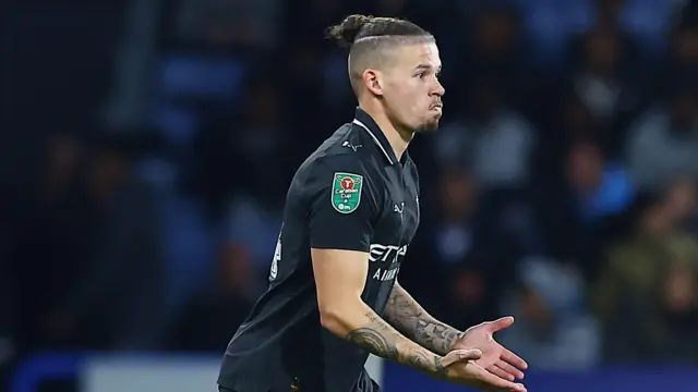 Kalvin Phillips playing football while wearing a black Manchester City away shirt