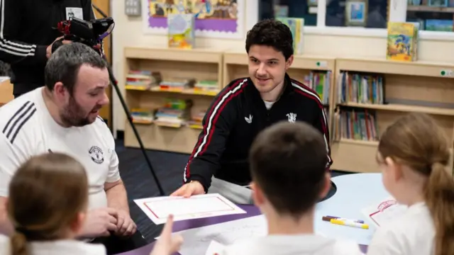 Manchester United goalkeeper Senne Lammens takes part in a World Book Day event at a local primary school on behalf of the club's foundation