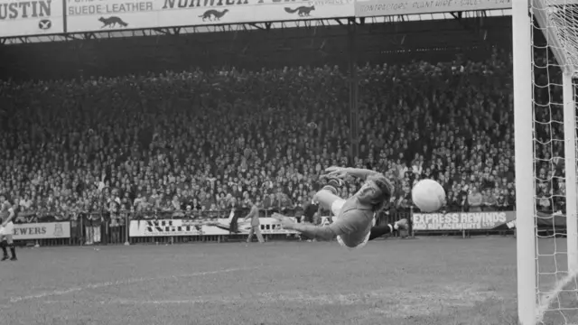 Manchester United goalkeeper Alex Stepney makes a save in 1974