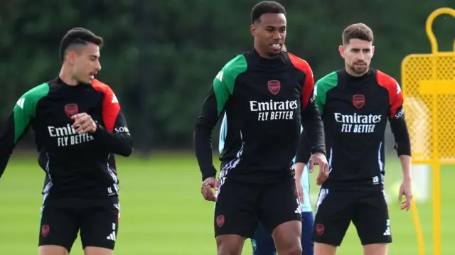 Arsenal players look on during a training session