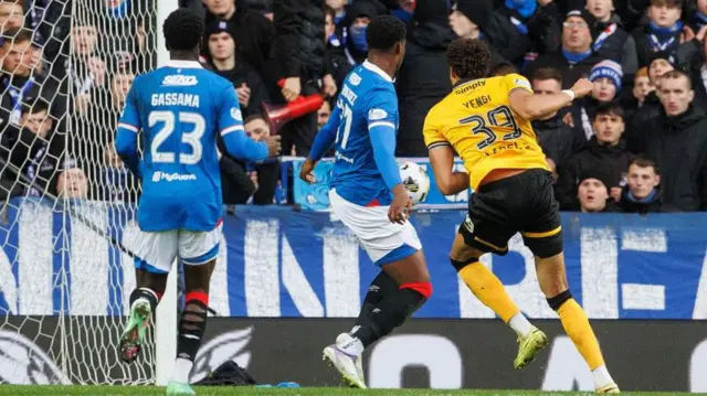 Rangers centre-half Emmanuel Fernandez (centre) is struck by Livingston striker Teti Yengi's shot