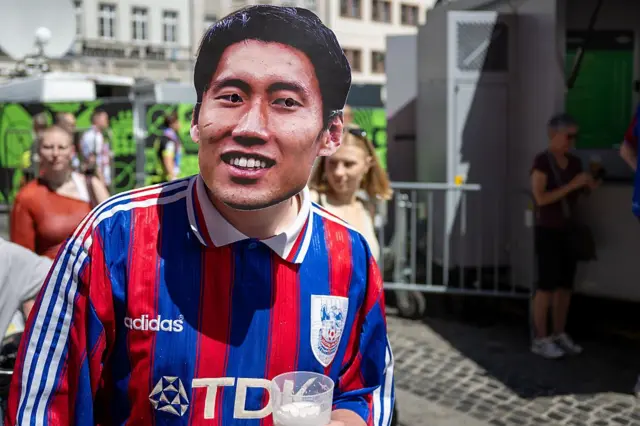 Crystal Palace fans wear Daichi Kamada masks