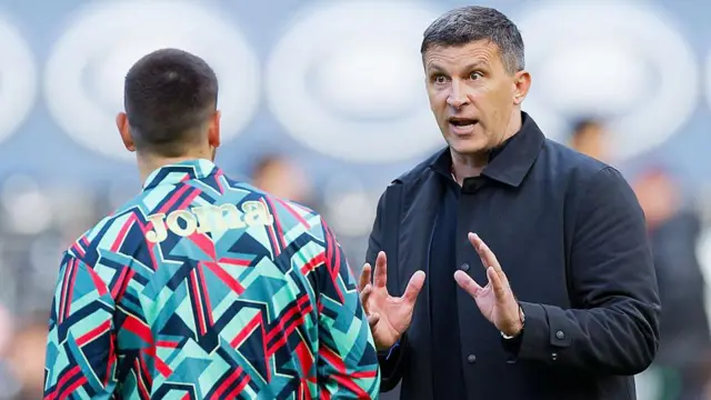 Sergej Jakirovic, head coach of Hull City, speaks with Zan Vipotnik of Swansea City