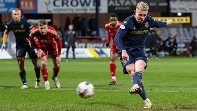 Luke McCowan scores a penalty for Dundee against Aberdeen