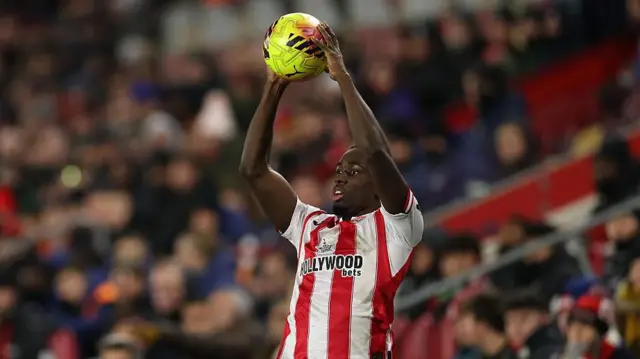 Michael Kayode takes a throw-in for Brentford