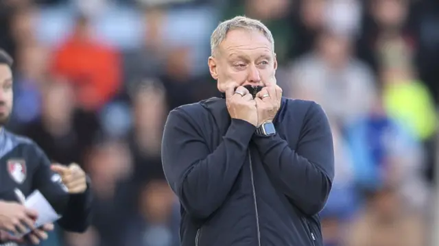 Steve Cooper watches Leicester's win over Bournemouth.