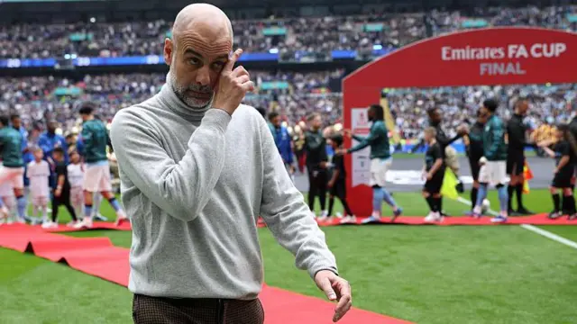 Pep Guardiola scratching his face after the FA Cup final win over Chelsea
