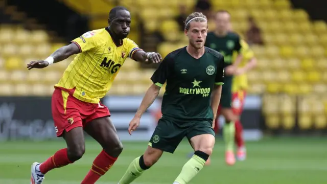  Mathias Jensen of Brentford moves away from Moussa Sissoko