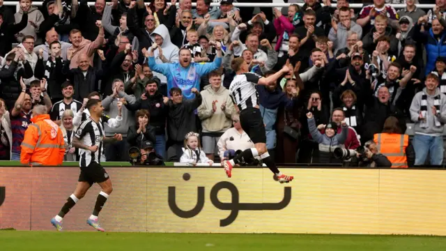 Newcastle players celebrate a goal against Manchester United