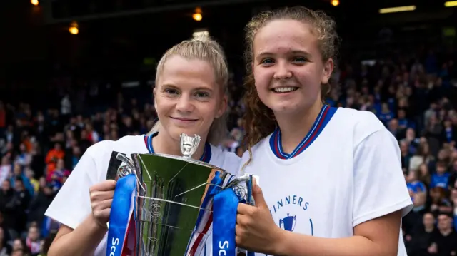 Brogan Hay (L) and Mia McAulay (R) with the Scottish Cup trophy