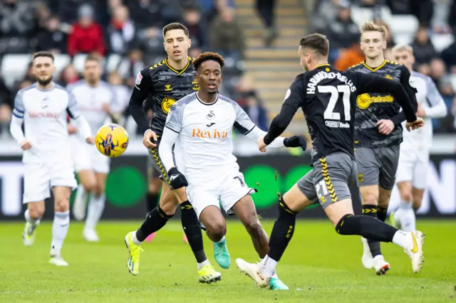 Jamal Lowe closes down Southampton defender Taylor Harwood-Bellisrr Taylor Harwood-Bellis with Flynn Downes and Jan Bednarek behind him