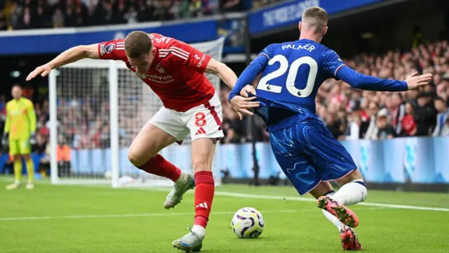 Cole Palmer of Chelsea battles for possession with Elliot Anderson of Nottingham Forest