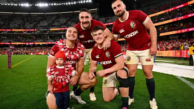 James Lowe and his son wearing garlands