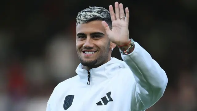 Andreas Pereira waves while smiling
