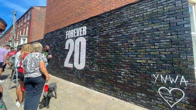 Fans gather at a 'Forever 20' mural dedicated to Diogo Jota