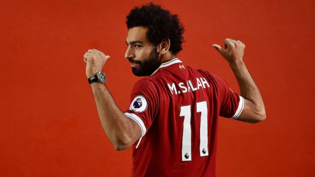 Mohamed Salah poses in a Liverpool shirt on the day he signed in 2017