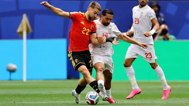 Belgium's Nicolas Raskin in action with Iran's Saman Ghoddos