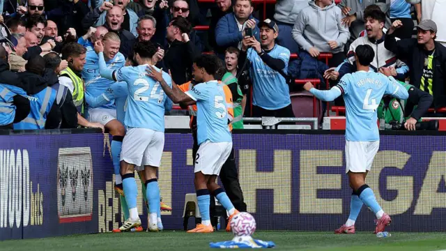 Erling Haaland of Manchester City celebrates with teammates and the fans