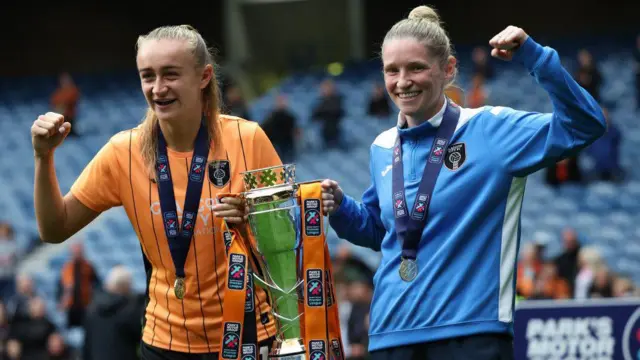 Glasgow City's Lauren Davidson (L) and head coach Leanne Ross with the trophy on the last day of the Scottish Women's Premier League season, on May 21, 2023