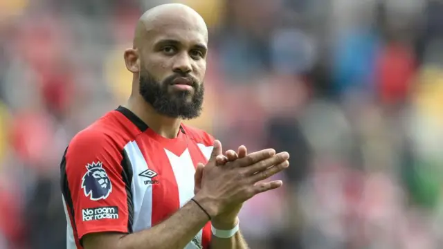 Bryan Mbeumo applauds the crowd while playing for Brentford. 