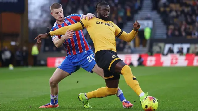 Adam Wharton tackles Tolu Arokodare