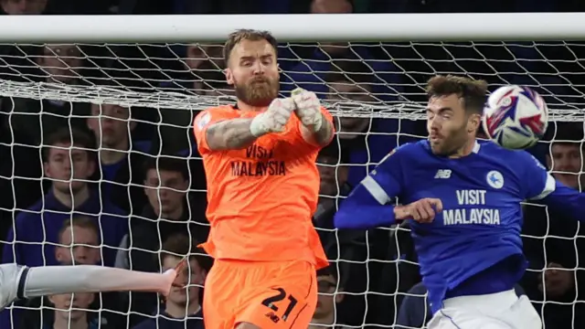 Jak Alnwick (left) punches the ball away