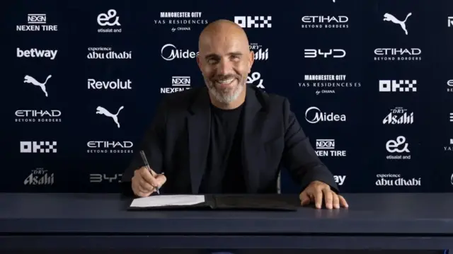 Enzo Maresca signing his Manchester City contract