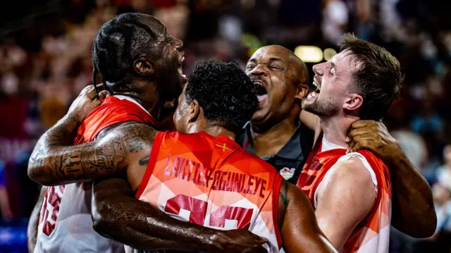 England men's 3x3 basketball team celebrate their gold medal