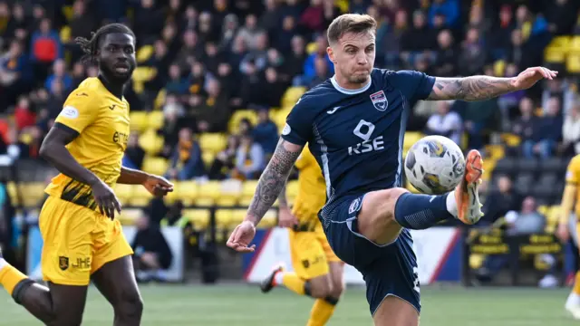 Ross County's Eamon n Brophy and Livingston's Mo Sangare in action 