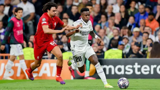 Trent Alexander-Arnold of Liverpool FC and Vinicius Junior of Real Madrid battle for the ball