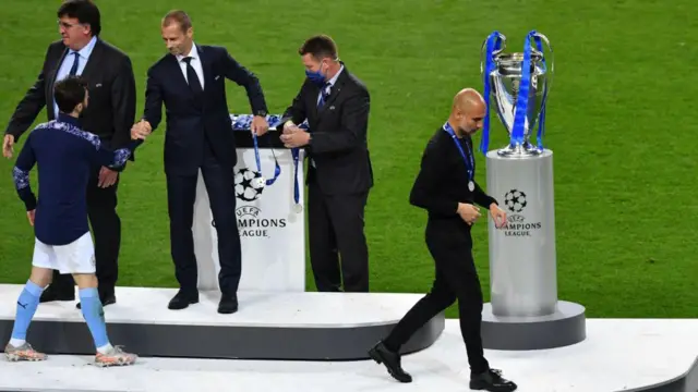 Pep Guardiola receives his Champions League runners up medal after the 2021 final