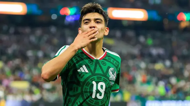 Gilberto Mora celebrating for Mexico by blowing a kiss