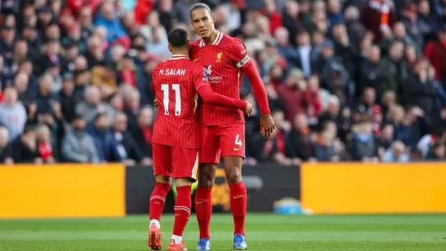 Mo Salah and Virgil van Dijk hug