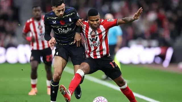 Reinildo Mandava of Sunderland holds off a challenge from Dwight McNeil of Everton during the Premier League match between Sunderland and Everton.