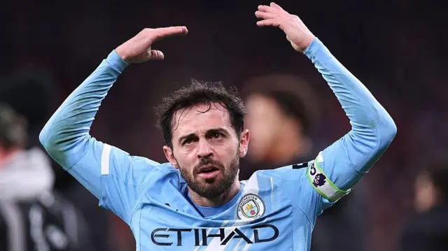Bernardo Silva lifts arms to encourage fans
